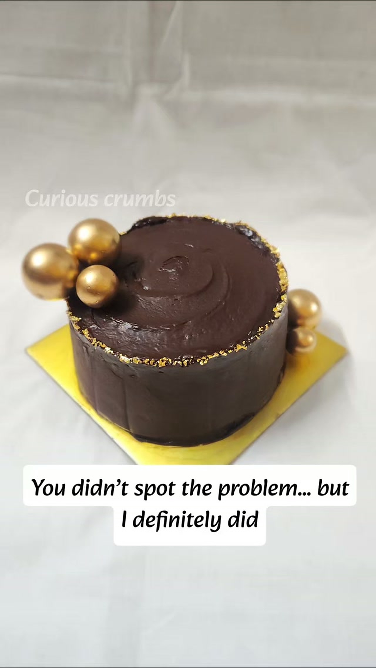 Dark chocolate celebration cake with gold accents